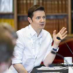 A judge asks a question of the presenting groups