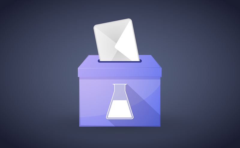 A white ballot envelope drops into a purple voting box that has a white beaker emblazoned on the side